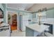 Bright kitchen with light blue cabinets and stainless steel appliances at 1640 Racquet Club Cir, Lawrenceville, GA 30043