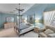 Comfortable bedroom with a canopy bed, ceiling fan, dresser with mirror, and an accent chair at 1640 Racquet Club Cir, Lawrenceville, GA 30043