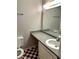 Bathroom featuring a large mirror, an extended countertop, and checkered flooring at 2574 Stratford Ln, Morrow, GA 30260