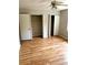 Spacious bedroom with hardwood floors, closets, and a ceiling fan for optimal comfort at 2574 Stratford Ln, Morrow, GA 30260