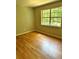Bright bedroom with a large window offering a view of nature and wood flooring at 2574 Stratford Ln, Morrow, GA 30260