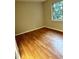 This bedroom features hardwood floors, neutral walls, and a window providing natural light at 2574 Stratford Ln, Morrow, GA 30260