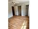 Bright bedroom features hardwood floors, closets, and a ceiling fan for optimal comfort at 2574 Stratford Ln, Morrow, GA 30260