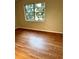 This bedroom features hardwood floors, neutral walls, and a window providing natural light at 2574 Stratford Ln, Morrow, GA 30260