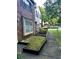 Exterior view of a brick home with a small side yard covered in moss and a sidewalk leading to the entrance at 2574 Stratford Ln, Morrow, GA 30260