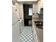 A kitchen featuring white cabinets, laminate countertop, tile walls, and a white and blue checkered floor at 2574 Stratford Ln, Morrow, GA 30260
