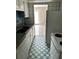 A kitchen featuring white cabinets, laminate countertop, tile walls, and a white and blue checkered floor at 2574 Stratford Ln, Morrow, GA 30260