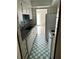 A kitchen featuring white cabinets, laminate countertop, tile walls, and a white and blue checkered floor at 2574 Stratford Ln, Morrow, GA 30260
