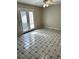 Living room with double doors to the backyard and tiled floors at 2574 Stratford Ln, Morrow, GA 30260