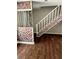 This living room features dark laminate floors, neutral walls, and a decorated stair case at 2574 Stratford Ln, Morrow, GA 30260