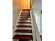 Carpeted staircase with white railing leading to the upper level at 2574 Stratford Ln, Morrow, GA 30260