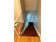 View of the wooden staircase with white railing leading down to a door and flooring at 2574 Stratford Ln, Morrow, GA 30260