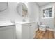 Bathroom featuring a single vanity, toilet, and a window providing natural light at 4647 Wonder Valley Trl, Decatur, GA 30034