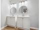 Modern bathroom showcasing double vanities with round mirrors and stylish lighting fixtures at 4647 Wonder Valley Trl, Decatur, GA 30034