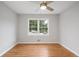 Empty bedroom features hardwood floors, ceiling fan, and a bright window at 4647 Wonder Valley Trl, Decatur, GA 30034