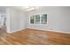 An open dining area features hardwood floors, modern lighting, and large windows overlooking the landscaped yard at 4647 Wonder Valley Trl, Decatur, GA 30034