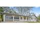 Charming single-story home featuring a two-car garage, gray trim, and a well-maintained front yard at 4647 Wonder Valley Trl, Decatur, GA 30034