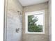 Shower stall with grey tile and a bright window at 4647 Wonder Valley Trl, Decatur, GA 30034