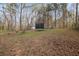 Large backyard with mature trees, a trampoline, and play equipment at 504 Trotters Ln, Mcdonough, GA 30252