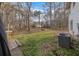 Green backyard featuring mature trees and an outdoor living space at 504 Trotters Ln, Mcdonough, GA 30252