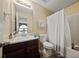 Bathroom featuring a shower and bathtub combo with dark wood vanity and a beige wall color at 504 Trotters Ln, Mcdonough, GA 30252