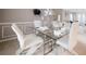 Contemporary dining room with a glass table, white chairs, and stylish decor at 504 Trotters Ln, Mcdonough, GA 30252