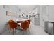 Eat-in kitchen features an elegant table with orange chairs and stylish decor, enhancing the dining experience at 504 Trotters Ln, Mcdonough, GA 30252