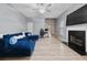 Living room featuring hardwood floors, fireplace, modern furniture, and an open floor plan at 504 Trotters Ln, Mcdonough, GA 30252