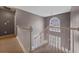 Staircase features a large window and white banister at 504 Trotters Ln, Mcdonough, GA 30252