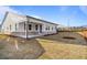 Wide view of home exterior and back yard with covered patio and newly seeded lawn at 1693 Juniper Berry Way, Loganville, GA 30052
