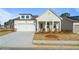 Charming single-Gathering home with a white facade, a two-car garage, and a well-manicured lawn at 1693 Juniper Berry Way, Loganville, GA 30052