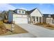 Charming single-Gathering home with a white facade, a two-car garage, and well-maintained landscaping at 1693 Juniper Berry Way, Loganville, GA 30052