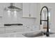 New kitchen showcases a quartz countertop, subway tile backsplash, and black faucet at 1693 Juniper Berry Way, Loganville, GA 30052