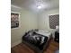 A quaint bedroom with neutral walls and hardwood flooring, featuring patterned curtains at 1032 Brian Ln, Forest Park, GA 30297
