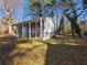 Inviting split-level home with charming brick details and a lush, tree-filled front yard at 1032 Brian Ln, Forest Park, GA 30297