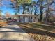 Two story home featuring black shutters, a well-manicured lawn, and mature shade trees at 1032 Brian Ln, Forest Park, GA 30297