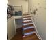 Hardwood stairs with painted risers and a decorative dandelion decal on the wall at 1032 Brian Ln, Forest Park, GA 30297