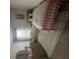 Bright bedroom with pink bedframe, patterned rug, butterfly artwork, and dresser at 11565 Kimberly Way # 24, Hampton, GA 30228