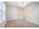 Bright bedroom features plush carpet, white walls, ceiling fan and double door closet at 1550 Woodberry Run Dr, Snellville, GA 30078