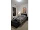 A cozy bedroom with a padded headboard, decorative pillows, and a stylish, patterned comforter at 3513 Kensington Parc Cir, Avondale Estates, GA 30002