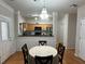 Charming dining area adjacent to the kitchen boasts modern lighting and provides views to the kitchen at 3513 Kensington Parc Cir, Avondale Estates, GA 30002