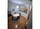 Bright dining area adjacent to the kitchen features hardwood floors, modern lighting, and neutral wall colors at 3513 Kensington Parc Cir, Avondale Estates, GA 30002