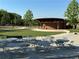 Outdoor venue features multiple tables and chairs with a covered stage for events at 3513 Kensington Parc Cir, Avondale Estates, GA 30002