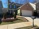 Charming two-story home with manicured landscaping and a brick-accented facade at 3513 Kensington Parc Cir, Avondale Estates, GA 30002