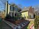 Inviting home with a well-maintained lawn, decorative landscaping, and a paved driveway at 3513 Kensington Parc Cir, Avondale Estates, GA 30002