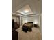 Bright main bedroom features a tray ceiling with recessed lights, neutral walls, and cozy sitting area at 3513 Kensington Parc Cir, Avondale Estates, GA 30002