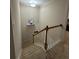 Well-lit staircase featuring neutral carpeting and white railings, with a quirky television set mounted on the wall at 3513 Kensington Parc Cir, Avondale Estates, GA 30002