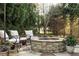Outdoor patio features a stone fire pit with comfortable seating, great for entertaining guests at 4025 Toulon Ln, Cumming, GA 30040