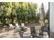 Outdoor stone patio features a fire pit, comfortable seating, a table, and string lights at 4025 Toulon Ln, Cumming, GA 30040