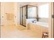 Bright bathroom features a soaking tub, separate glass enclosed shower, and linen closet at 4025 Toulon Ln, Cumming, GA 30040